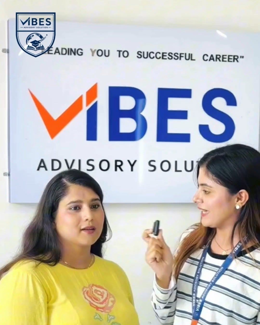 Two counsellors at the VIBES wall sign, Milanchowk office